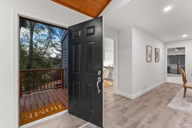 entryway featuring light wood-type flooring, wood ceiling, and vaulted ceiling