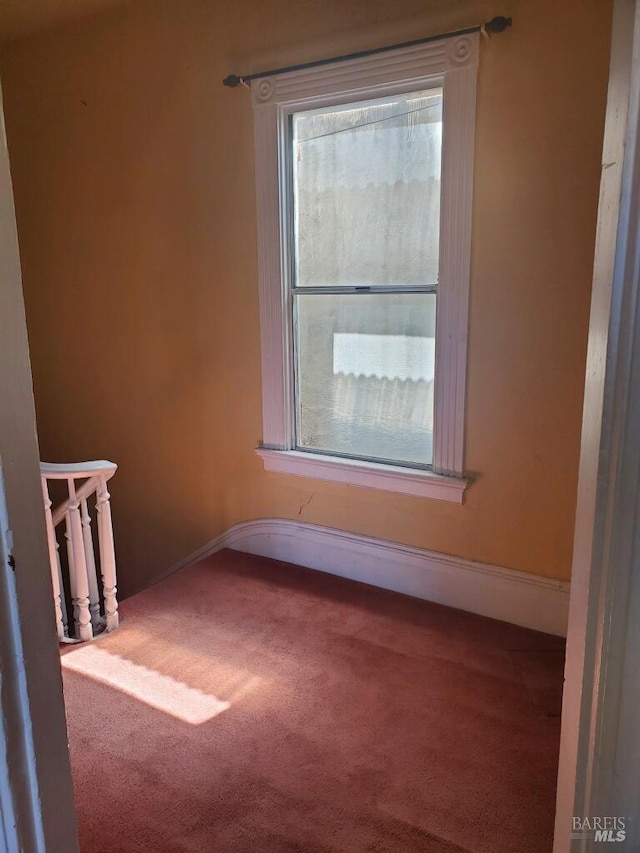 carpeted spare room with a healthy amount of sunlight