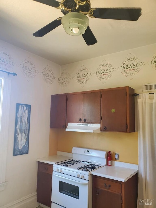 kitchen featuring ceiling fan and gas range gas stove