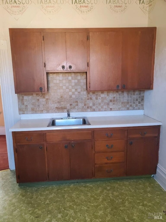 kitchen with backsplash and sink