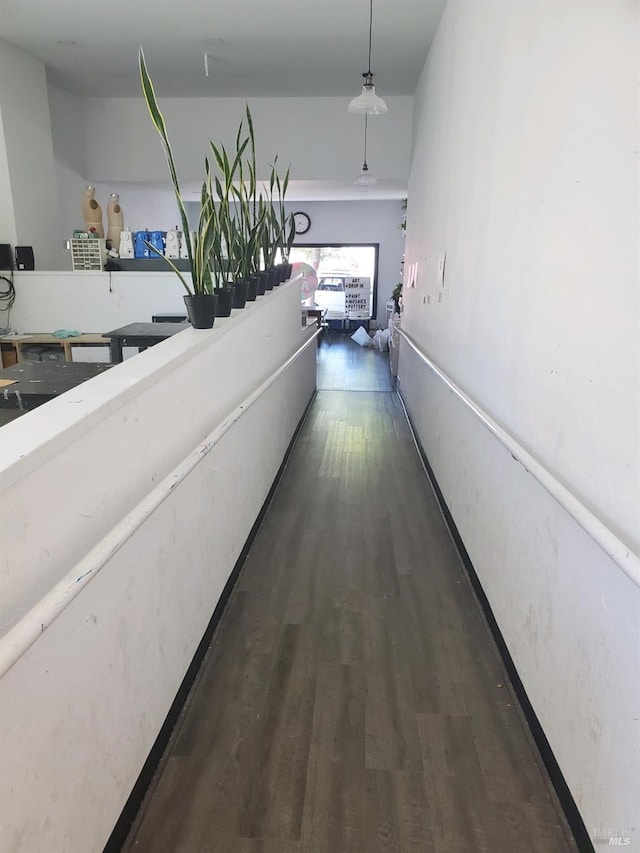 corridor featuring dark hardwood / wood-style flooring