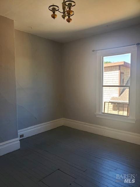 spare room featuring dark wood-type flooring