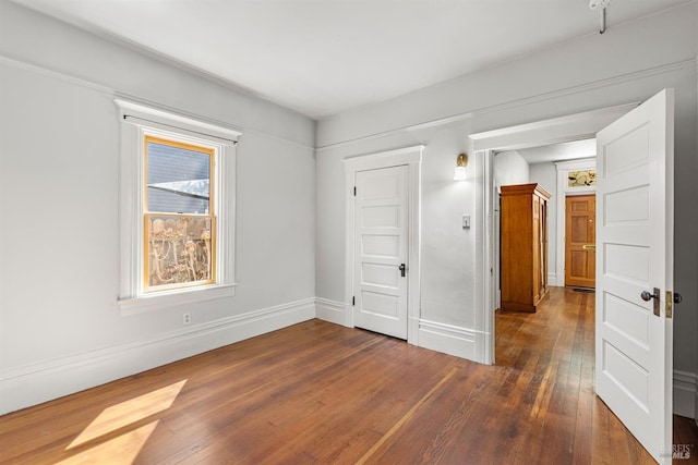 unfurnished room with dark hardwood / wood-style floors