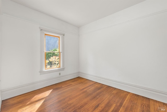 empty room with hardwood / wood-style floors