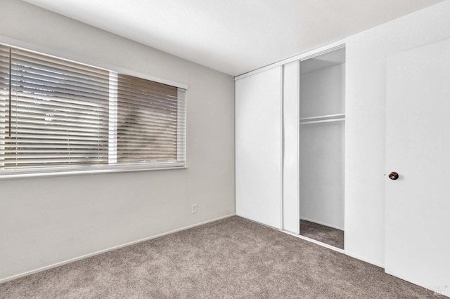 unfurnished bedroom featuring a closet and carpet flooring