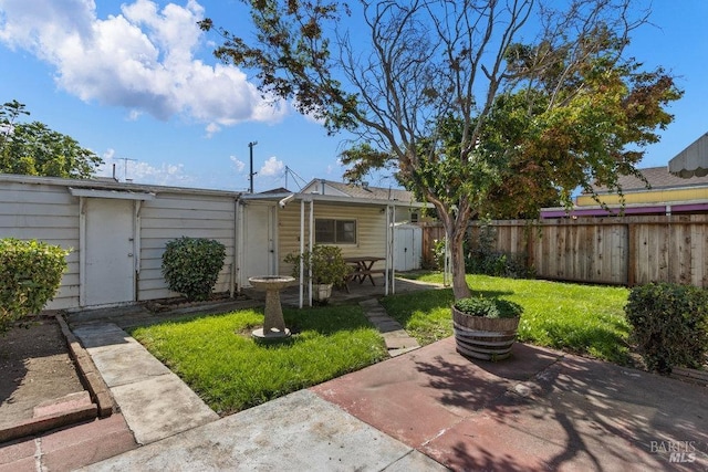 back of property with a lawn, a patio area, and fence