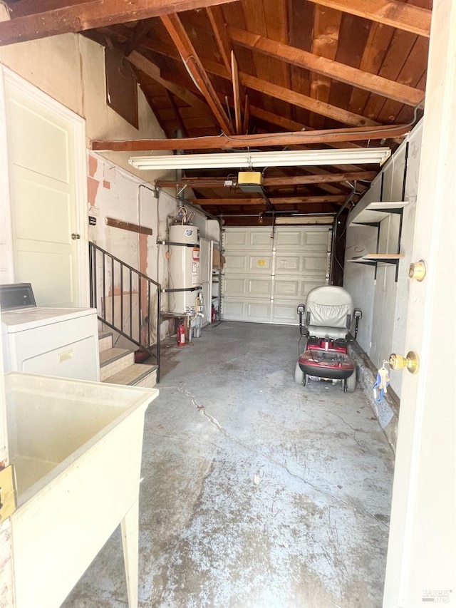garage featuring washer / clothes dryer, secured water heater, and a sink