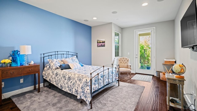 bedroom featuring access to exterior and dark hardwood / wood-style flooring