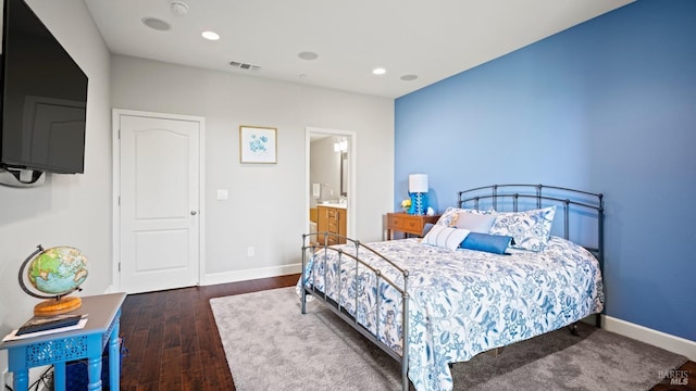 bedroom featuring dark wood-type flooring and connected bathroom