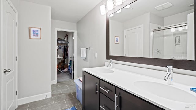 bathroom featuring vanity, a shower with shower door, and tile patterned floors