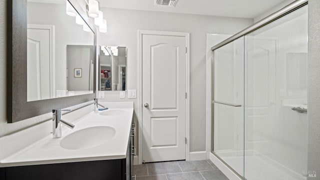 bathroom with vanity, a shower with shower door, and tile patterned flooring