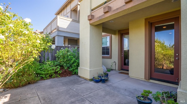 doorway to property with a balcony and a patio area