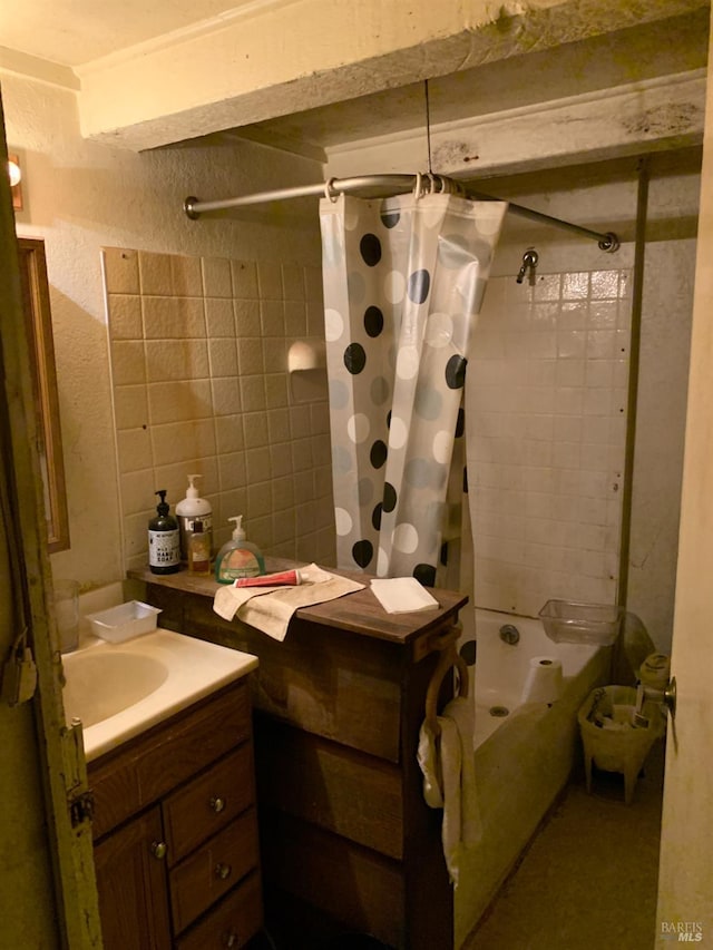 bathroom featuring shower / bath combo and vanity