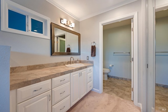 bathroom featuring ornamental molding, vanity, and toilet