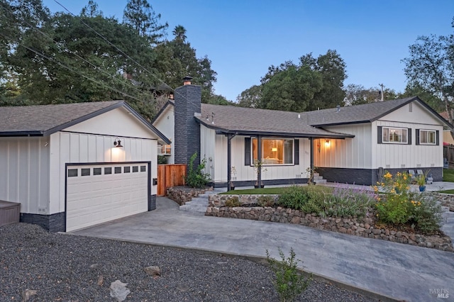 view of front of property with covered porch and a garage