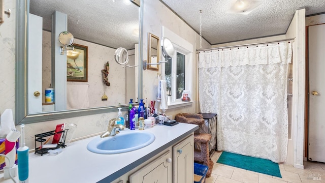 bathroom with tile patterned floors, vanity, and a textured ceiling