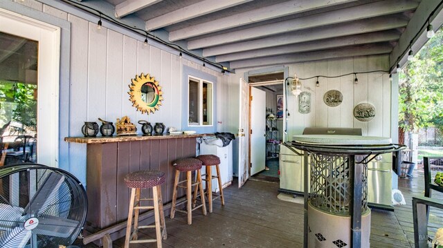 view of patio / terrace featuring a wooden deck and an outdoor bar