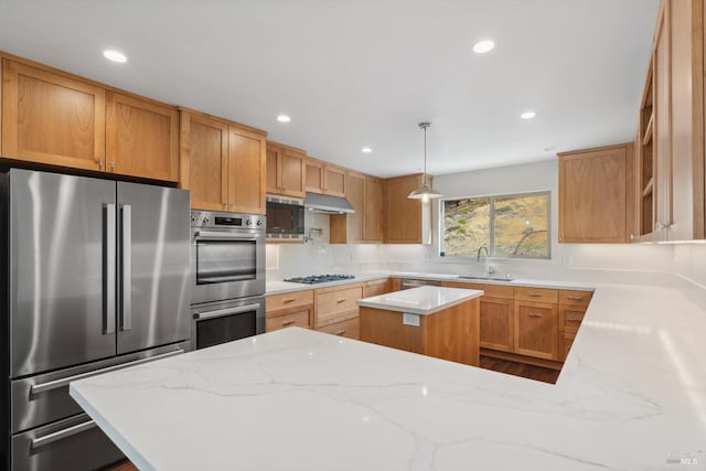 kitchen featuring hanging light fixtures, sink, kitchen peninsula, stainless steel appliances, and light stone countertops