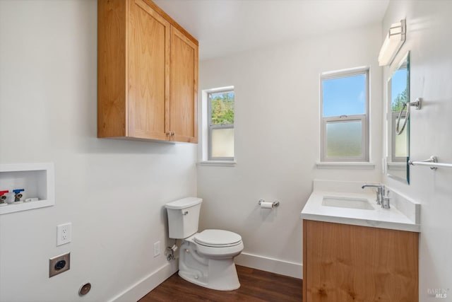 bathroom featuring hardwood / wood-style flooring, vanity, and toilet