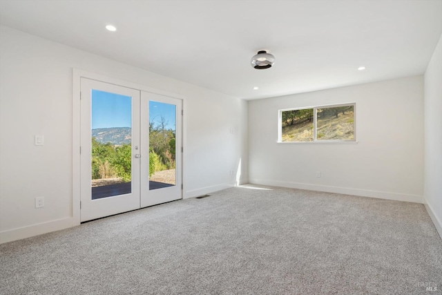 empty room featuring carpet and french doors