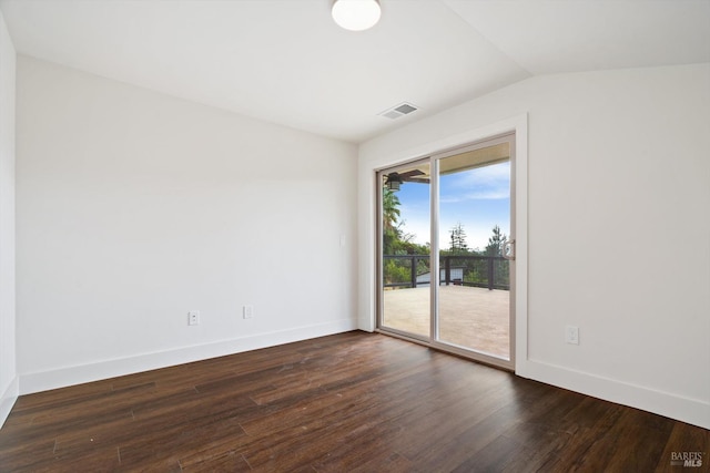 unfurnished room featuring lofted ceiling and dark hardwood / wood-style floors