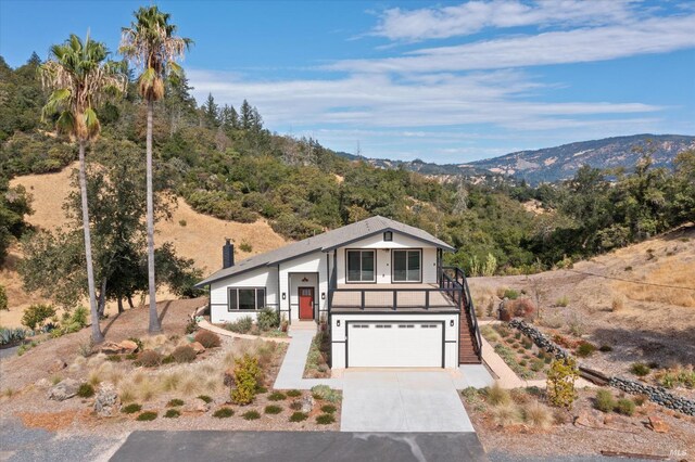 view of front of home with a mountain view and a garage