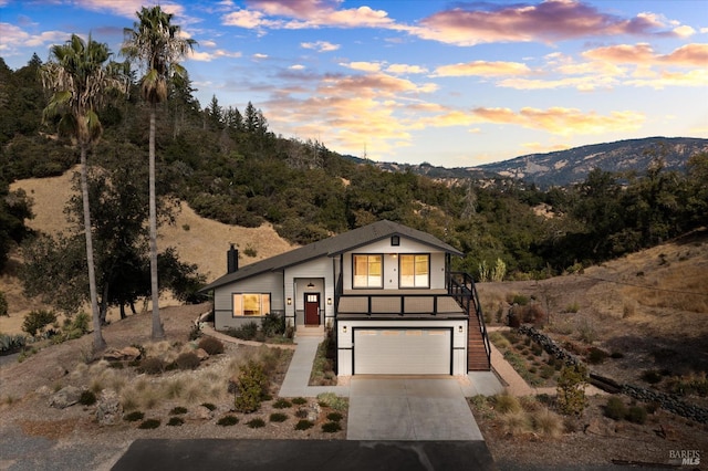 view of front facade with a garage and a mountain view