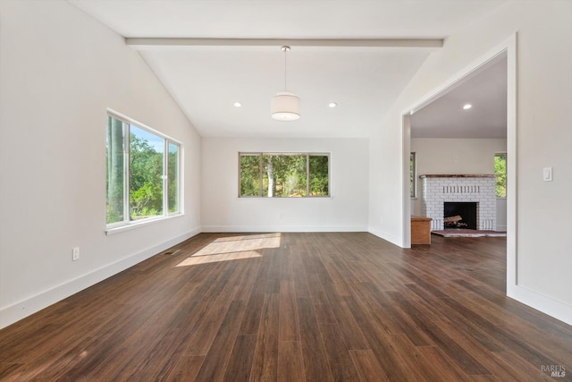 unfurnished living room featuring a brick fireplace, vaulted ceiling with beams, and dark hardwood / wood-style flooring