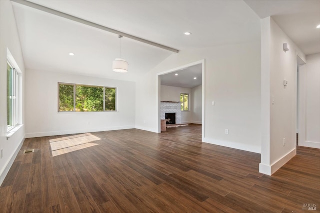 unfurnished living room featuring vaulted ceiling with beams, a fireplace, and dark hardwood / wood-style flooring