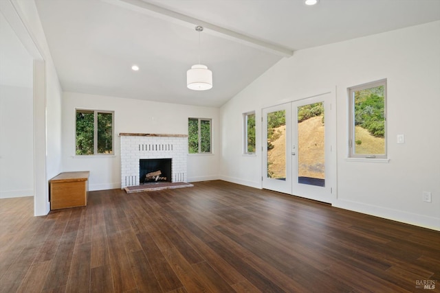 unfurnished living room with a brick fireplace, lofted ceiling with beams, and dark hardwood / wood-style flooring