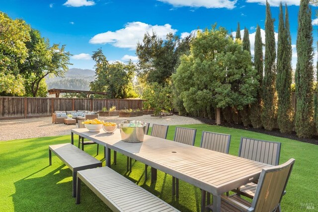 view of patio with an outdoor living space and a mountain view