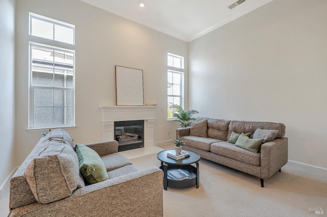 carpeted living room featuring crown molding