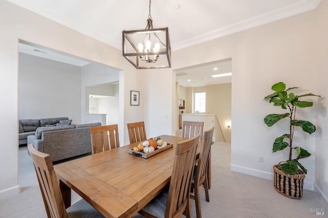 carpeted dining space featuring crown molding and an inviting chandelier