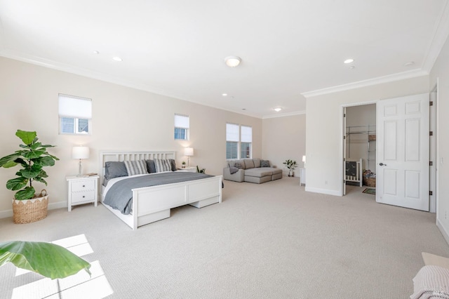 carpeted bedroom featuring a walk in closet, ornamental molding, and a closet