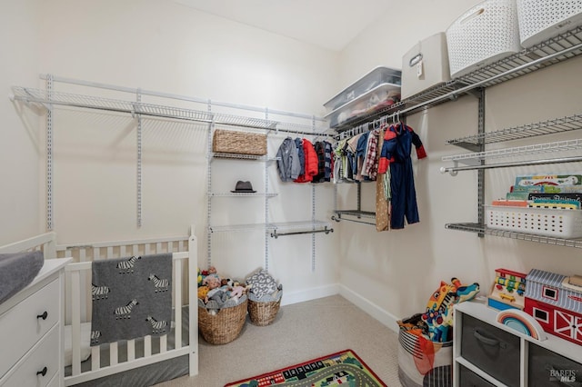 walk in closet with carpet floors