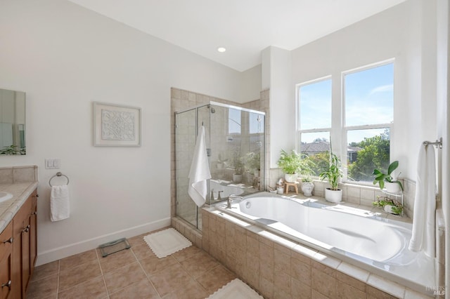 bathroom with tile patterned floors, vanity, and shower with separate bathtub