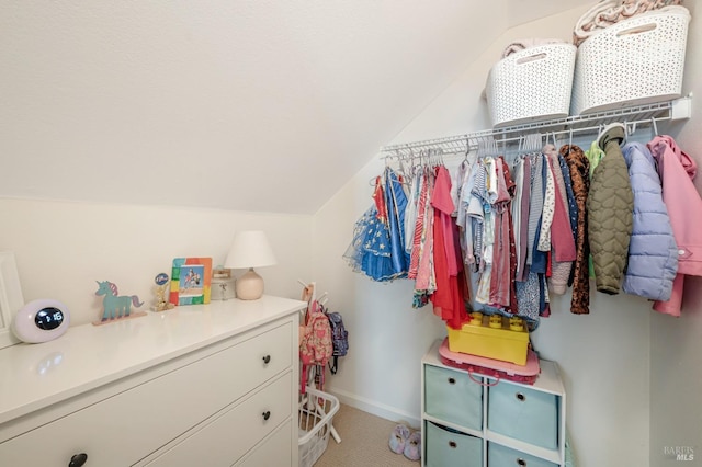 walk in closet featuring lofted ceiling