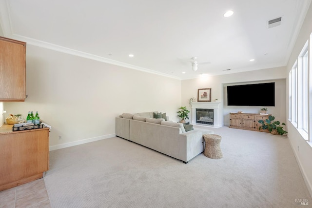 carpeted living room featuring ceiling fan, crown molding, and a wealth of natural light