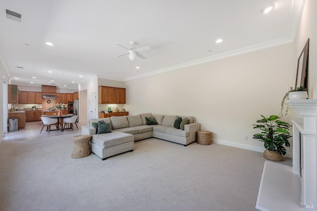 carpeted living room with crown molding and ceiling fan