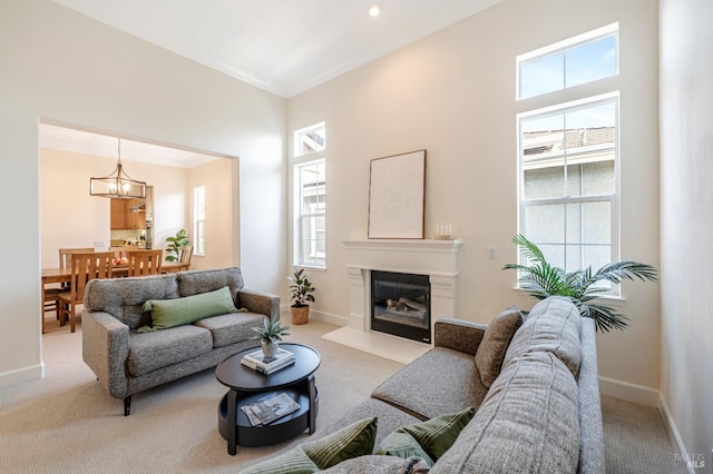 living room featuring crown molding, light carpet, and a chandelier