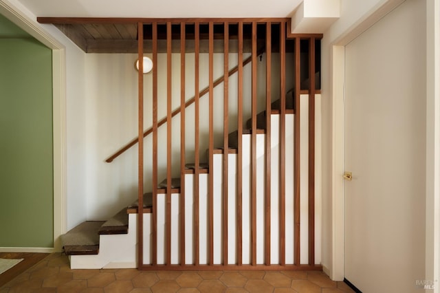 staircase featuring tile patterned floors