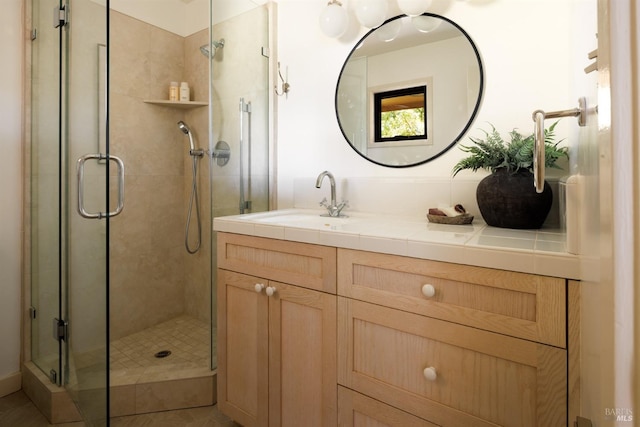 bathroom with walk in shower and vanity