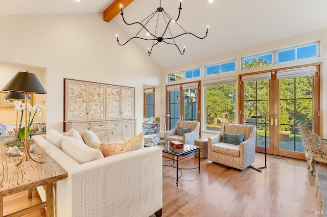 interior space with vaulted ceiling with beams, plenty of natural light, an inviting chandelier, and french doors