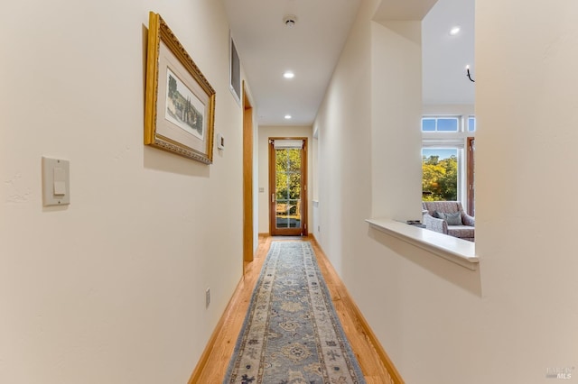 hallway with hardwood / wood-style flooring