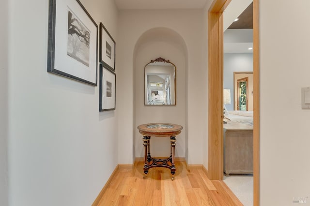 hall featuring wood finished floors and baseboards