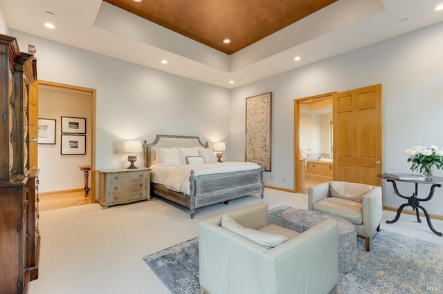 bedroom featuring light carpet, a raised ceiling, and recessed lighting