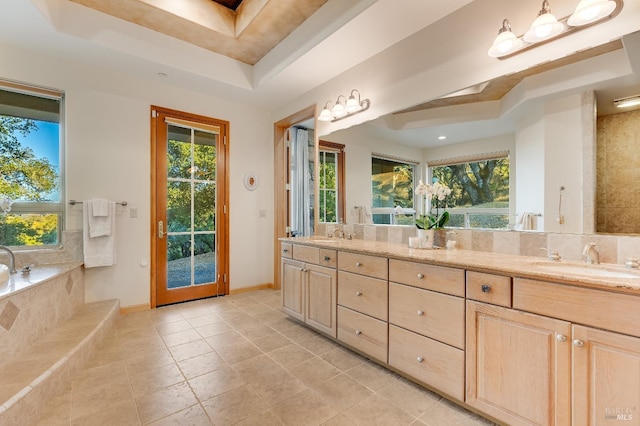 bathroom with tile patterned floors, vanity, and a raised ceiling