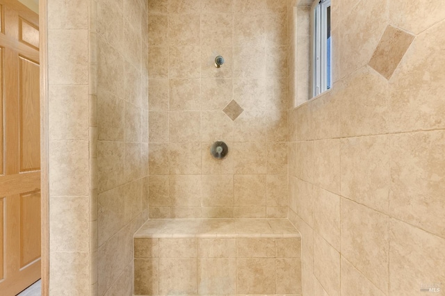 bathroom with tiled shower