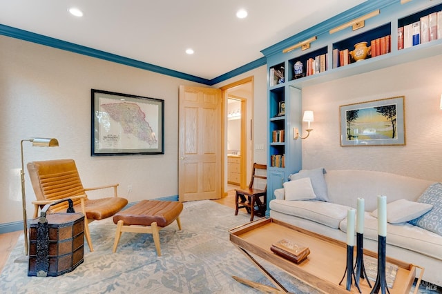 sitting room with built in features, recessed lighting, baseboards, and ornamental molding