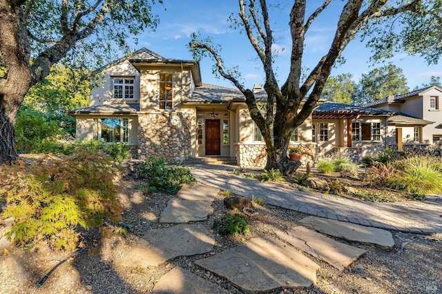 mediterranean / spanish-style home featuring stone siding and stucco siding